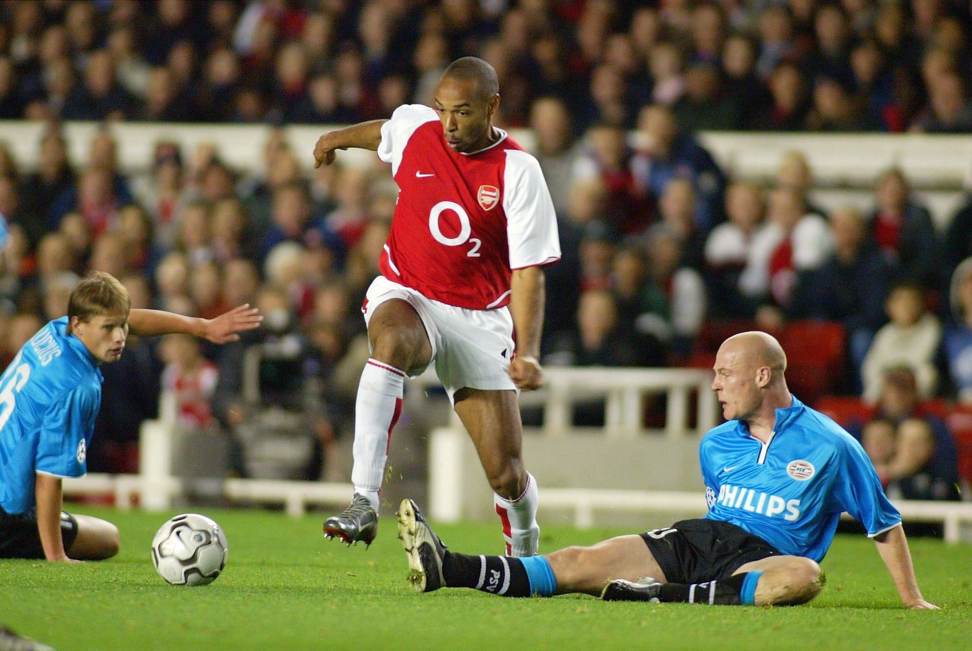 Thierry Henry of Arsenal holds off Kasper Bogelund of PSV