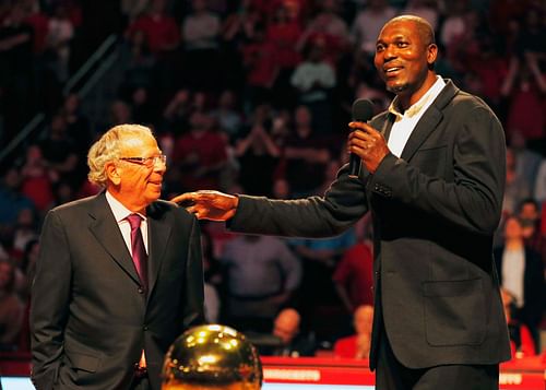 Fomer Houston Rocket Hakeem Olajuwon speaks to the crowd alongside team owner Leslie Alexander as the team honors the 20th anniversary of back-to-back NBA championships at halftime of their game against the Denver Nuggets on March 19, 2015, in Houston.