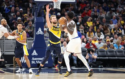 Domantas Sabonis of the Indiana Pacers defends Julius Randle