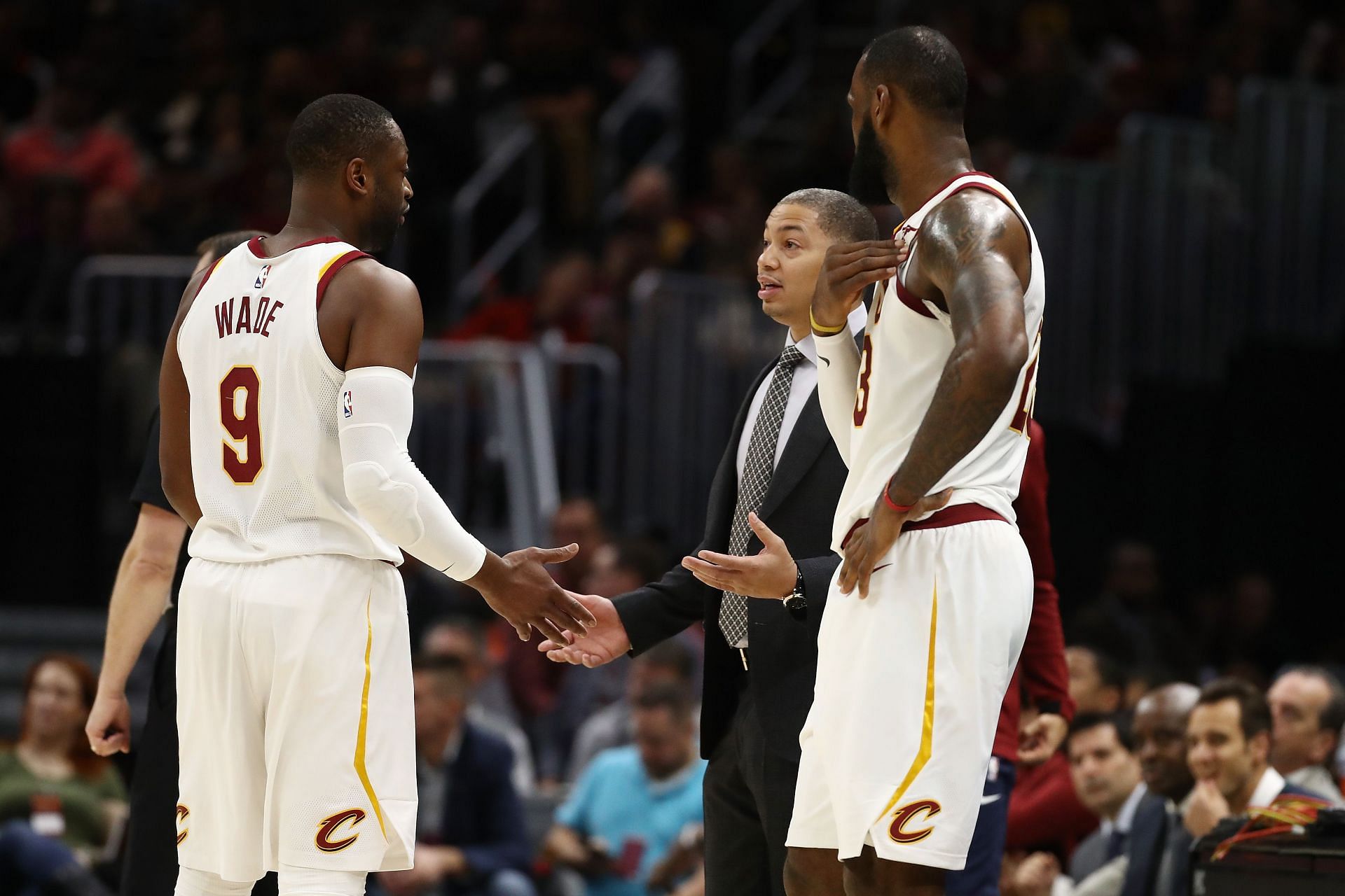 Tyronn Lue talking to Dwyane Wade (left) and LeBron James (right).