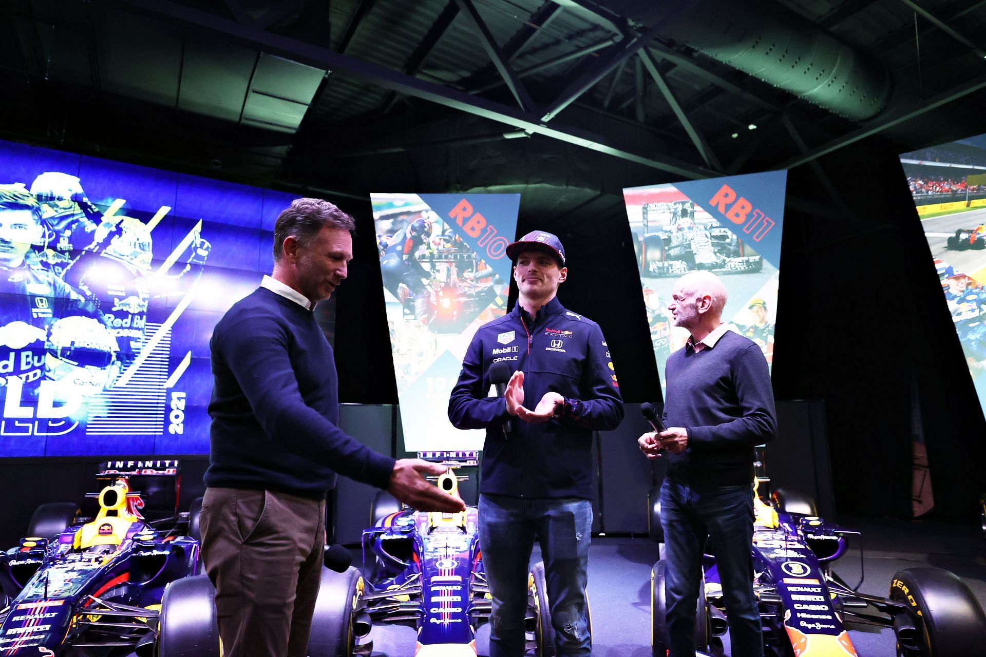 F1 world champion Max Verstappen (center) at Red Bull Racing Factory with team principal Christian Horner (left) and chief technology officer Adrian Newey (right)
