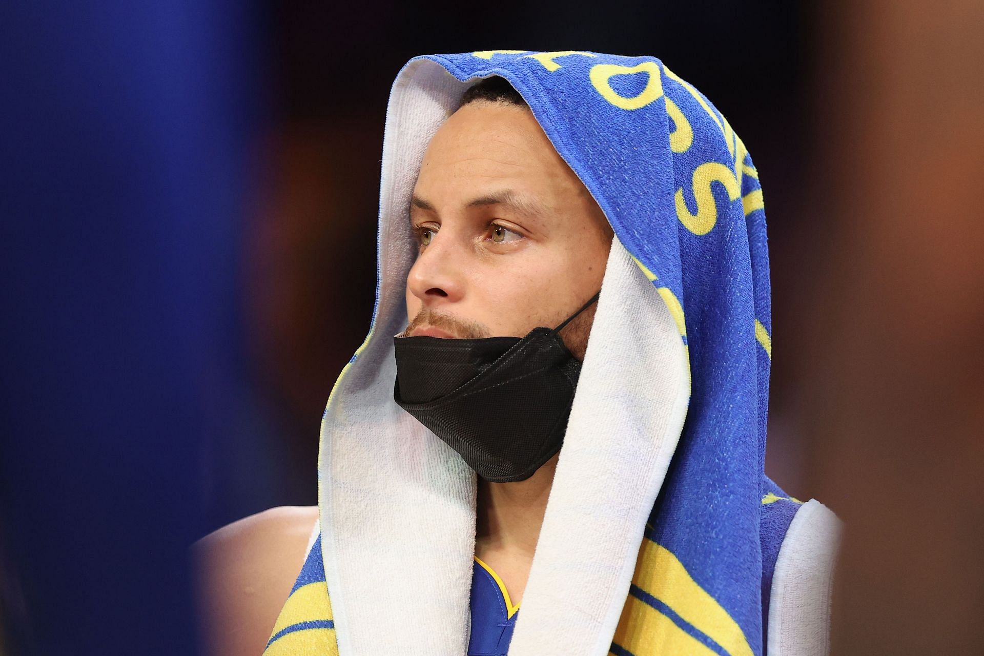 Steph Curry looks on from the bench during Golden State Warriors v Phoenix Suns