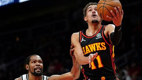 Trae Young #11 of the Atlanta Hawks drives against Kevin Durant #7 of the Brooklyn Nets