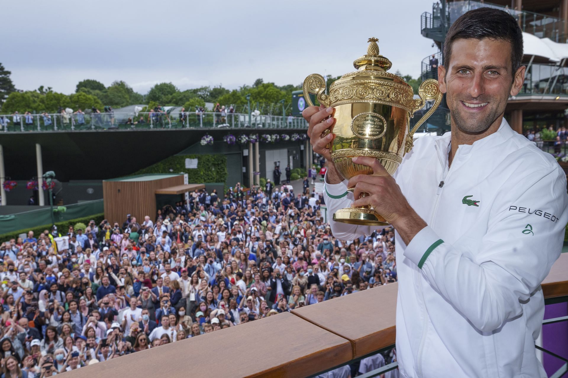 Novak Djokovic celebrates with the 2021 Wimbledon men's singles trophy