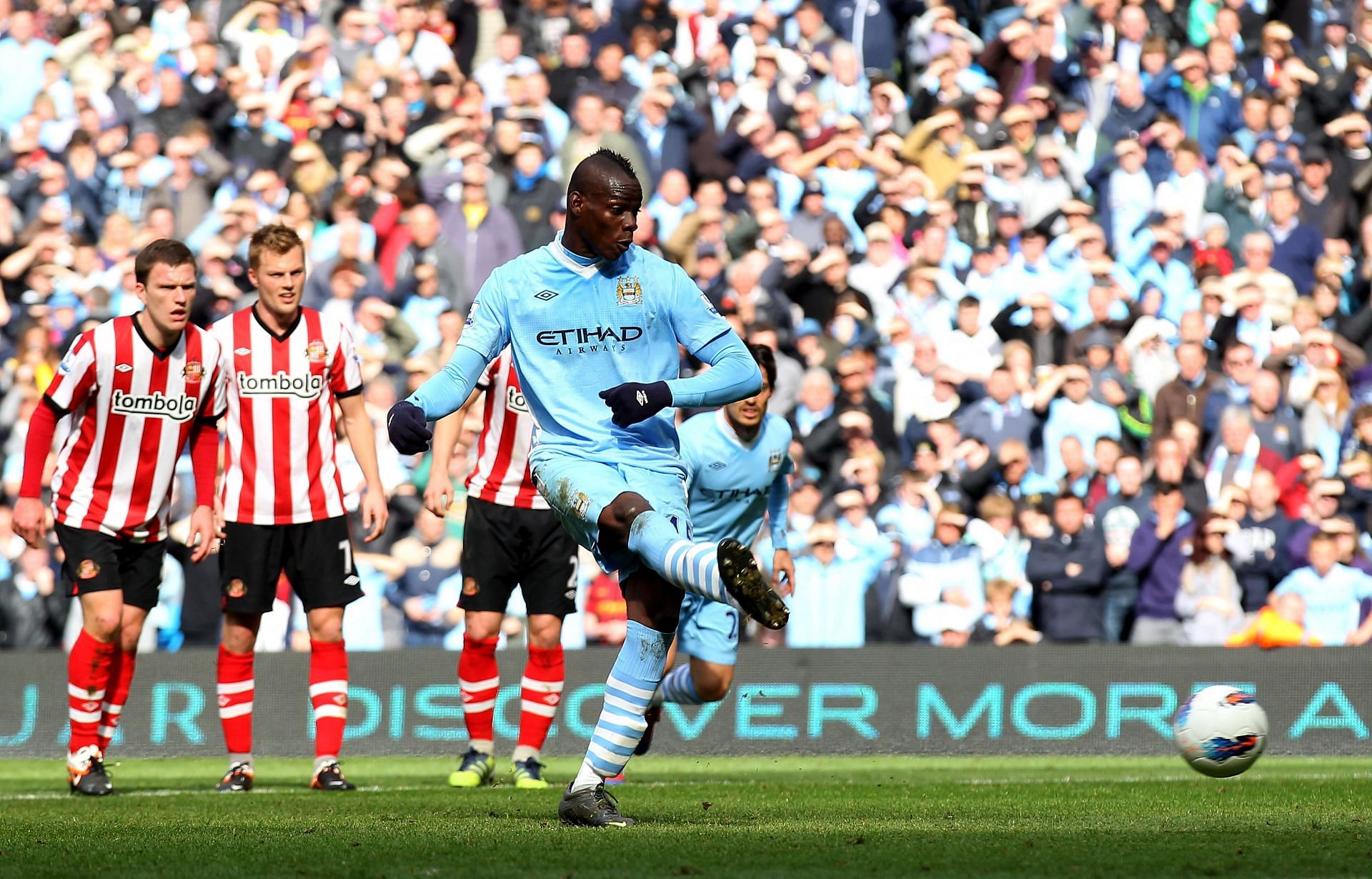 Mario Balotelli scores from the spot for Manchester City.