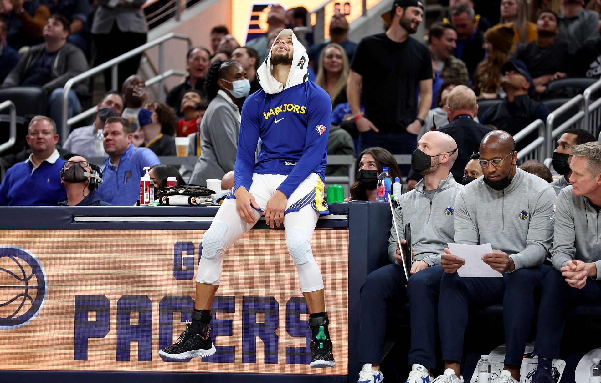 Steph Curry of the Golden State Warriors sits on the scorer&#039;s table at Indianapolis