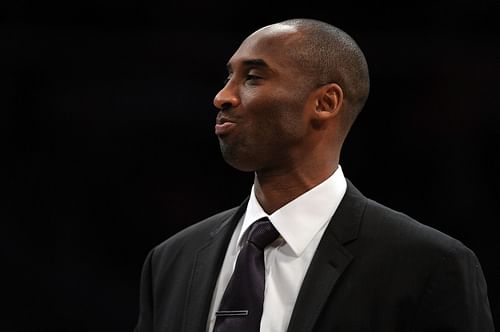 Kobe Bryant watches the game against the Dallas Mavericks.