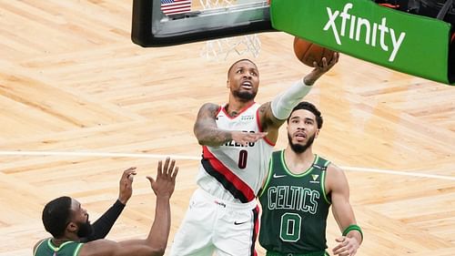 Damian Lillard of the Portland Trail Blazers scores in front of Boston Celtics' Jayson Tatum [Source: USA Today]