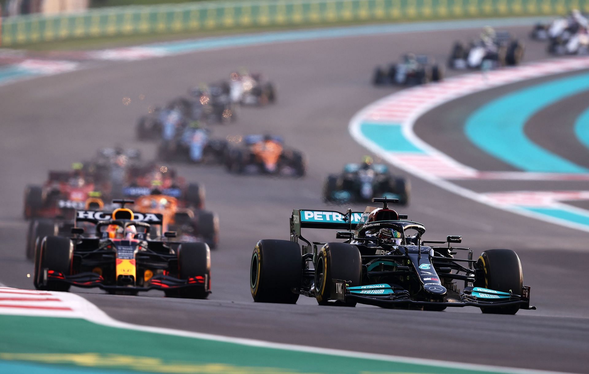 Max Verstappen (left) driving the Red Bull RB16B overtook Lewis Hamilton (right) in the Mercedes W12 on the last lap of the 2021 Abu Dhabi Grand Prix to clinch his first F1 world championship