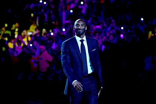 Kobe Bryant smiles at halftime as both his #8 and #24 Los Angeles Lakers jerseys are retired at Staples Center