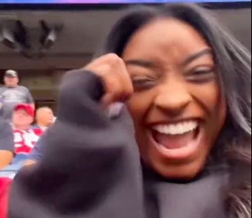 Simone Biles celebrates Jonathan Owens' interception