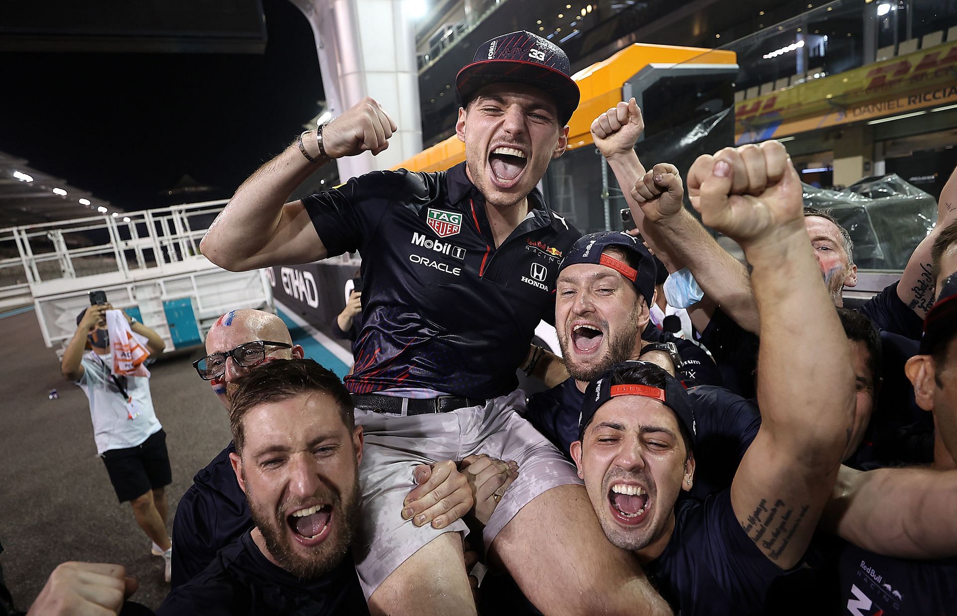 Race winner and 2021 F1 World Drivers&#039; Champion Max Verstappen celebrates with his team after the Abu Dhabi Grand Prix.