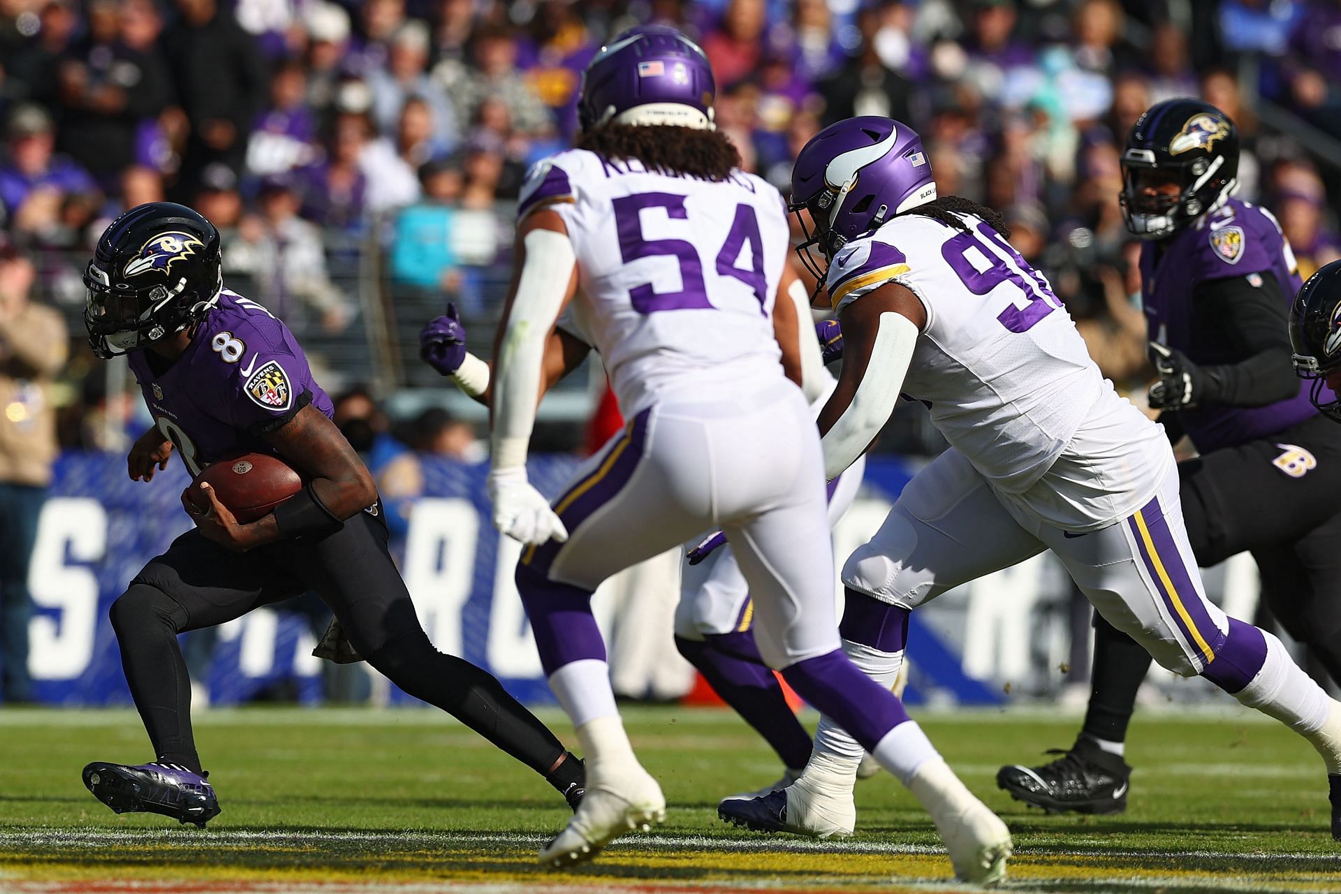 Baltimore Ravens quarterback Lamar Jackson on the run from defenders