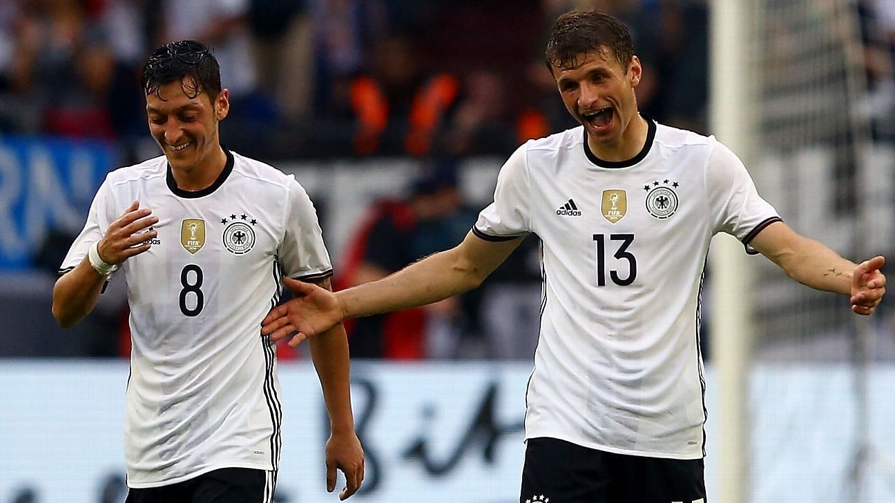 Mesut Ozil  (left)and Thomas Muller share a light-hearted moment after a Germany goal in a game.