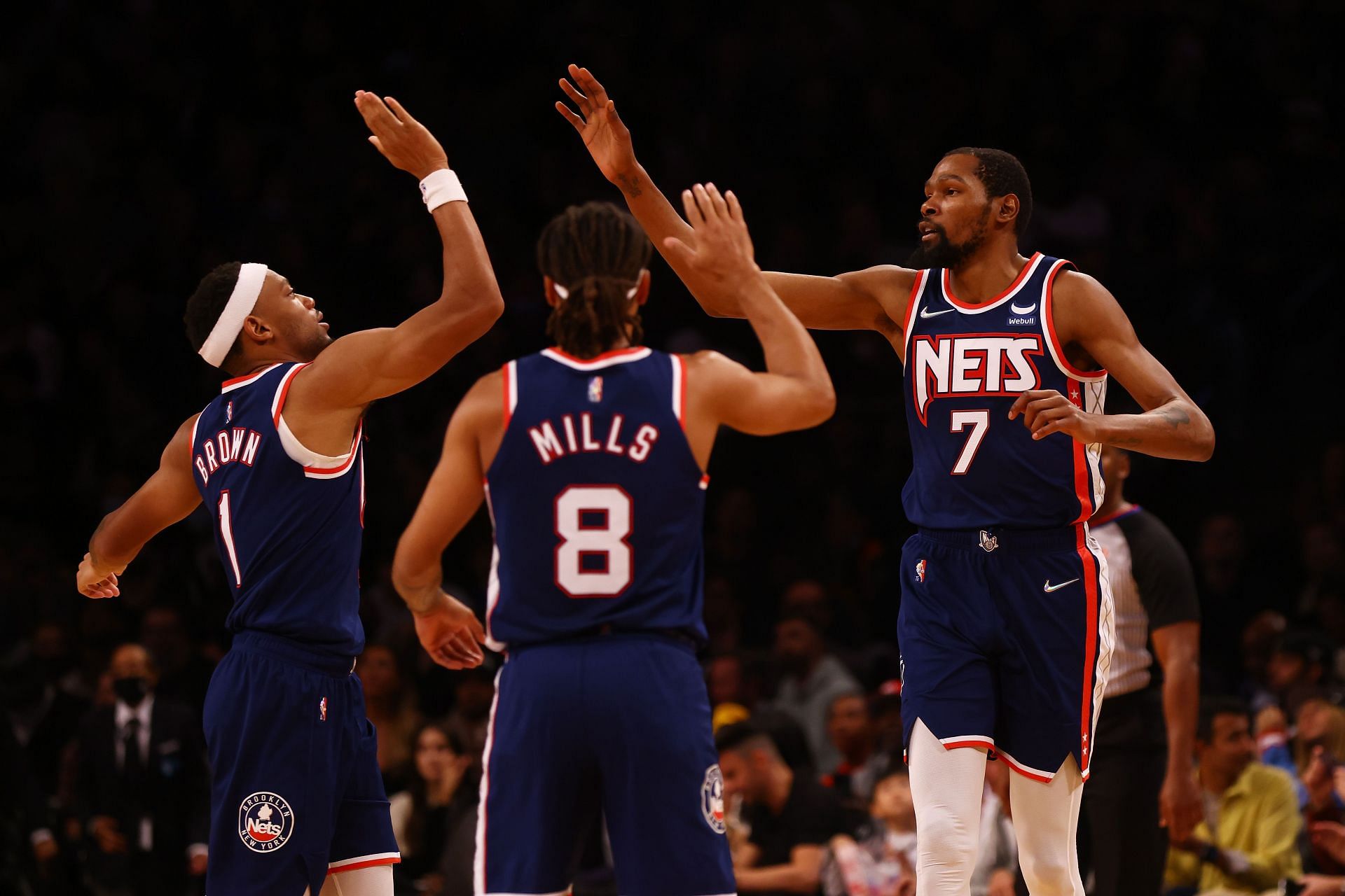 Kevin Durant #7 of the Brooklyn Nets celebrates after making a basket with Bruce Brown #1 and Patty Mills #8