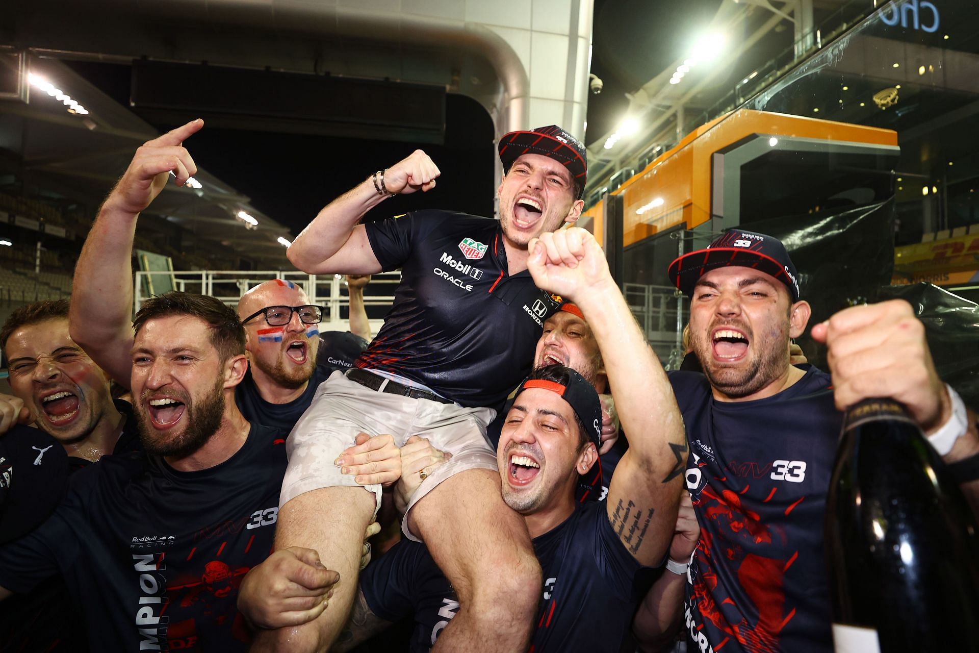 Race winner and 2021 F1 World Drivers Champion Max Verstappen celebrates with his team after the 2021 Abu Dhabi Grand Prix. (Photo by Bryn Lennon/Getty Images)