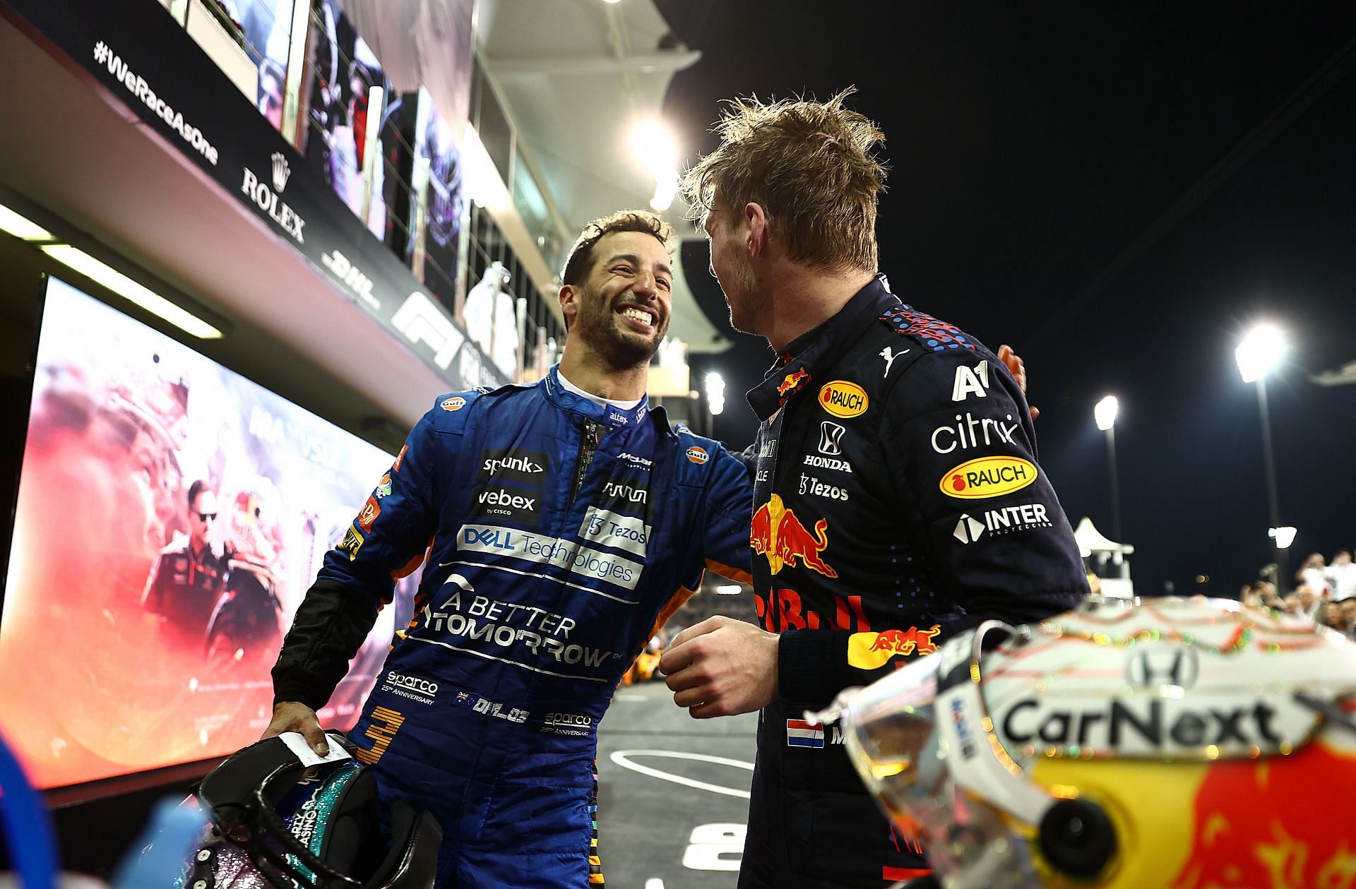 Daniel Ricciardo (left) congratulates Max Verstappen (right) on winning his maiden F1 world championship, 2021 Abu Dhabi Grand Prix