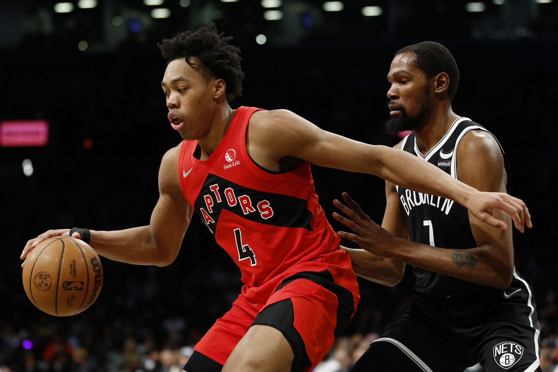 Scottie Barnes is guarded by Kevin Durant.