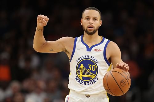 Stephen Curry of the Golden State Warriors handles the ball during the NBA game at Footprint Center on Nov. 30, 2021, in Phoenix, Arizona. The Suns defeated the Warriors 104-96.