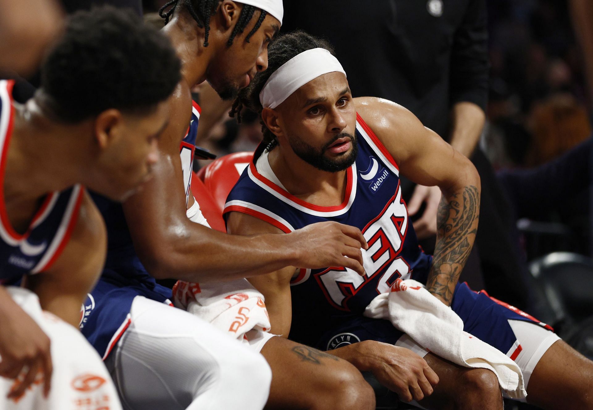 David Duke Jr. and Patty Mills of the Brooklyn Nets talk during a timeout