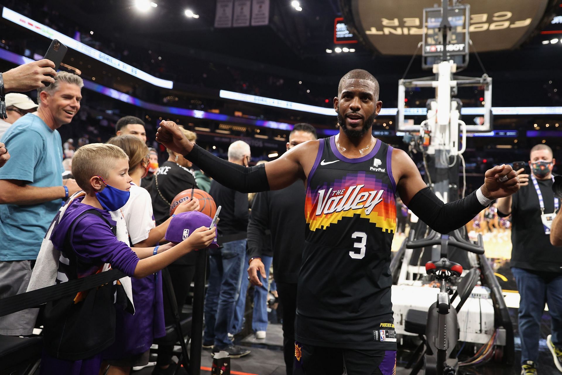 Chris Paul #3 of the Phoenix Suns high fives fans following the NBA game against the Golden State Warriors at Footprint Center on November 30, 2021 in Phoenix, Arizona. The Suns defeated the Warriors 104-96.