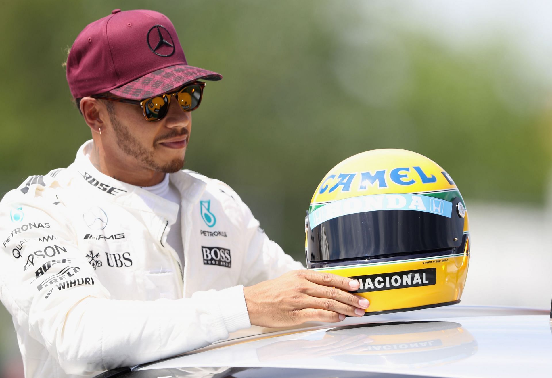 Lewis Hamilton with a replica of an Ayrton Senna helmet (Photo by Mark Thompson/Getty Images)