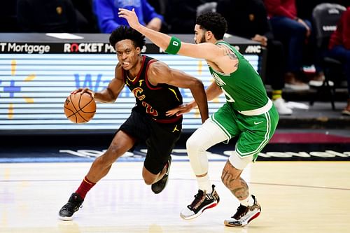 Jayson Tatum (L) of the Boston Celtics guards Collin Sexton of the Cleveland Cavaliers