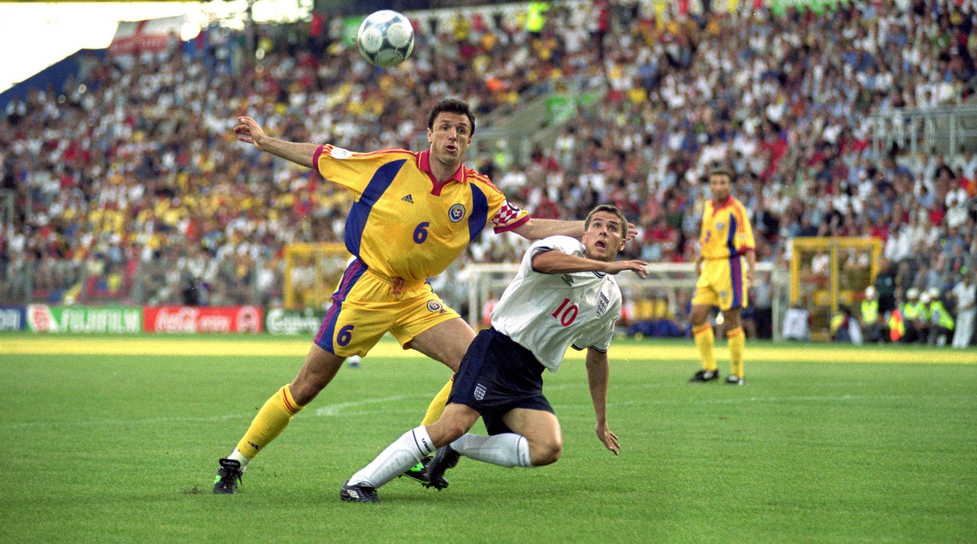 Former football player, Gheorghe Popescu (No.6) of Romania tussles with Michael Owen (No.10) of England during the European Championships 2000 Group A match at the Stade Communal, Charleroi, Belgium.
