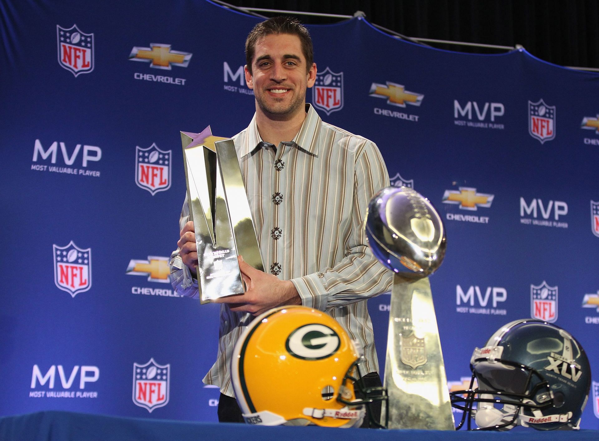 Rodgers with the Lombardi and MVP trophy for winning the Super Bowl in 2010