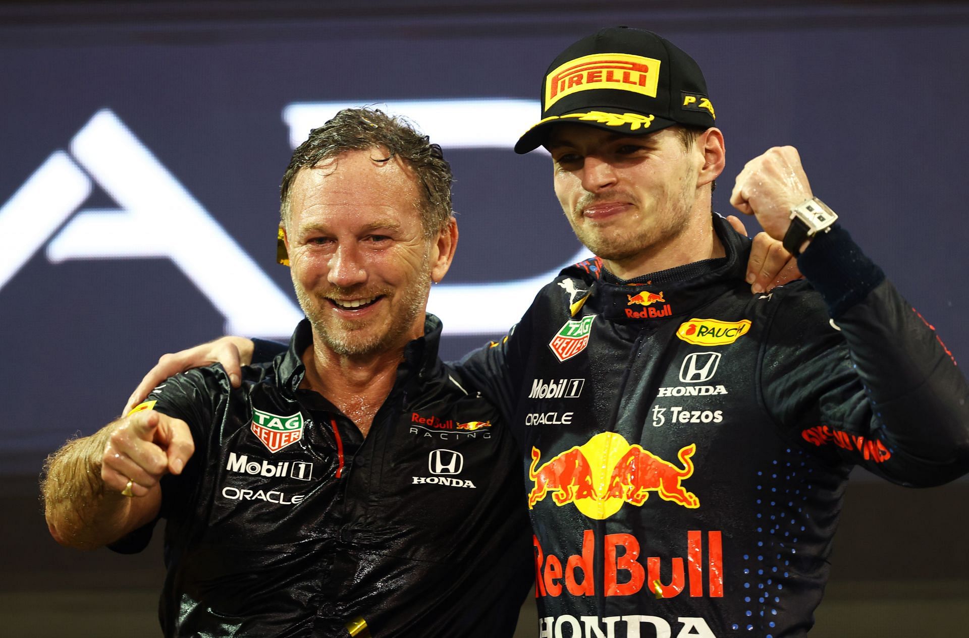 Race winner and 2021 F1 World Drivers Champion Max Verstappen with Red Bull Racing Team Principal Christian Horner on the podium during the 2021 Abu Dhabi Grand Prix. (Photo by Bryn Lennon/Getty Images)