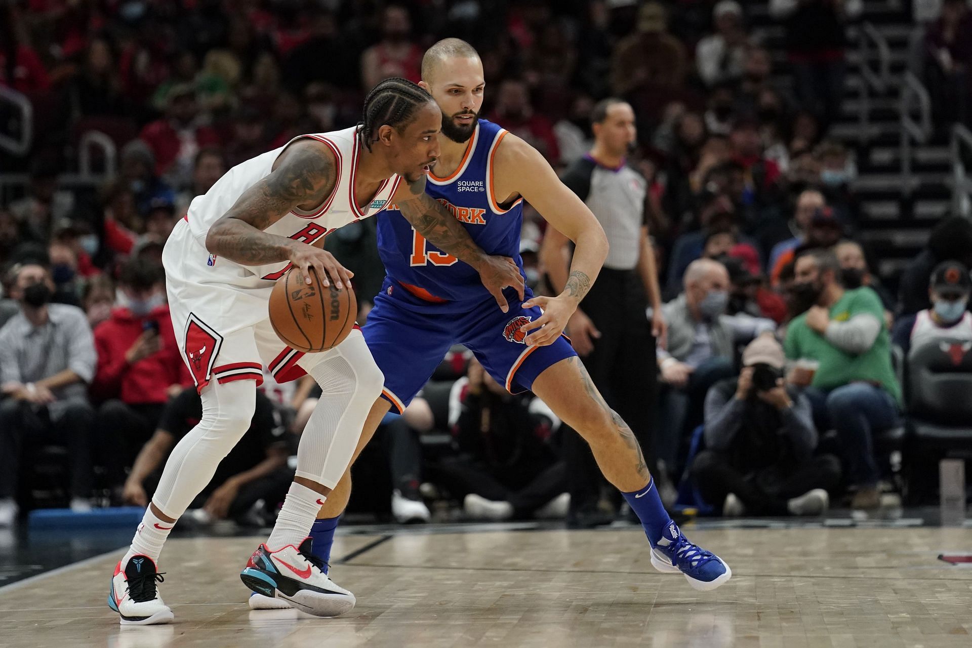 DeMar DeRozan #11 of the Chicago Bulls dribbles the ball against Evan Fournier #13 of the New York Knicks in the first half at United Center on November 21, 2021 in Chicago, Illinois.