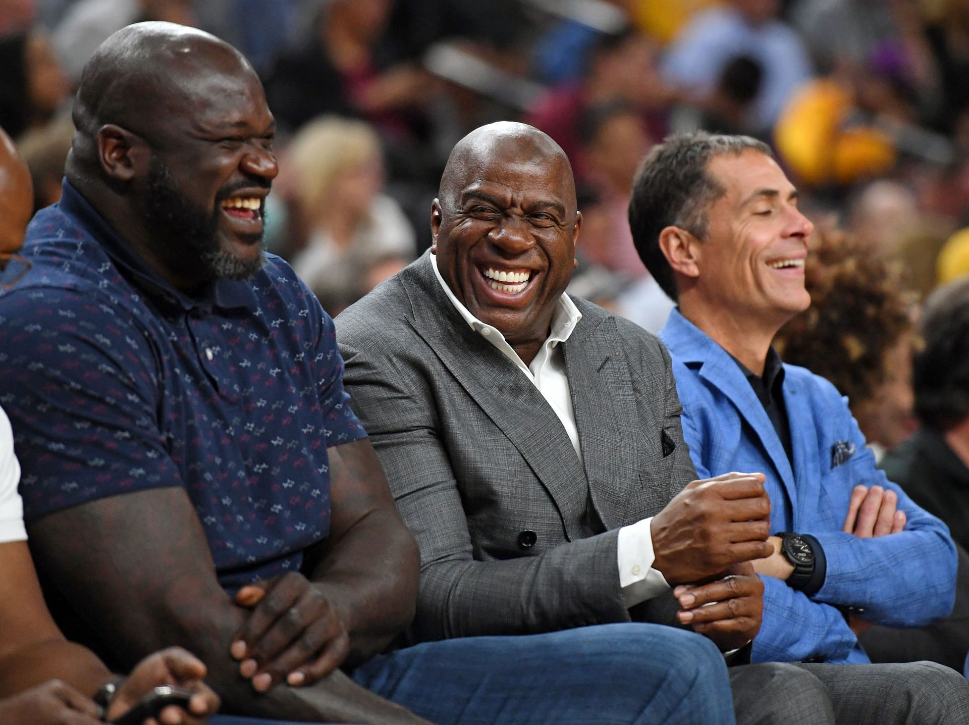NBA analyst Shaquille O&#039;Neal, Los Angeles Lakers president of basketball operations Earvin &quot;Magic&quot; Johnson and Lakers general manager Rob Pelinka share a laugh during the Lakers&#039; preseason game against the Golden State Warriors at T-Mobile Arena on October 10, 2018 in Las Vegas, Nevada.