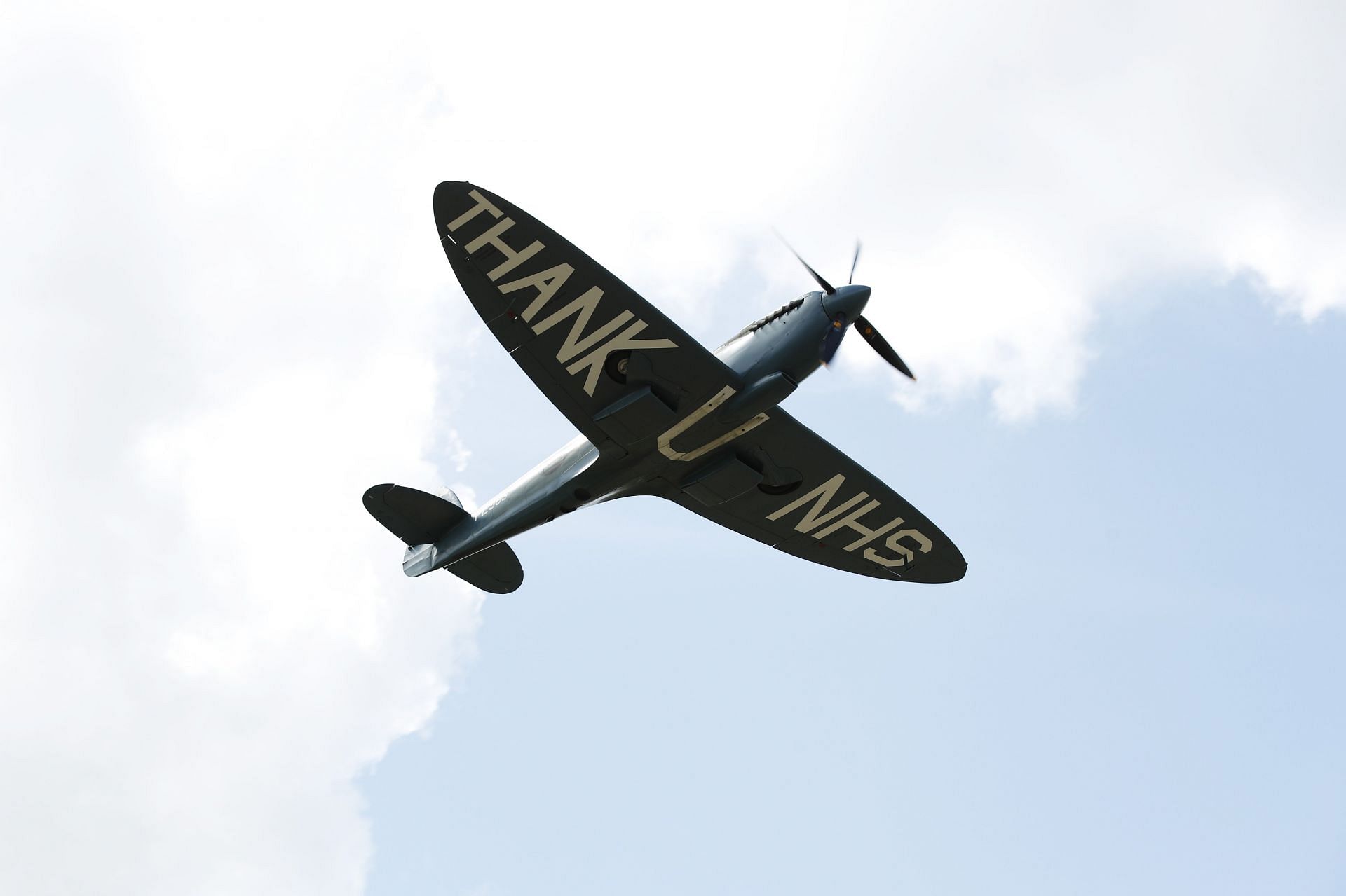 A WW2-era Supermarine Spitfire flies over the Silverstone circuit before the 2020 British Grand Prix (Photo by Andrew Boyers/Pool via Getty Images)