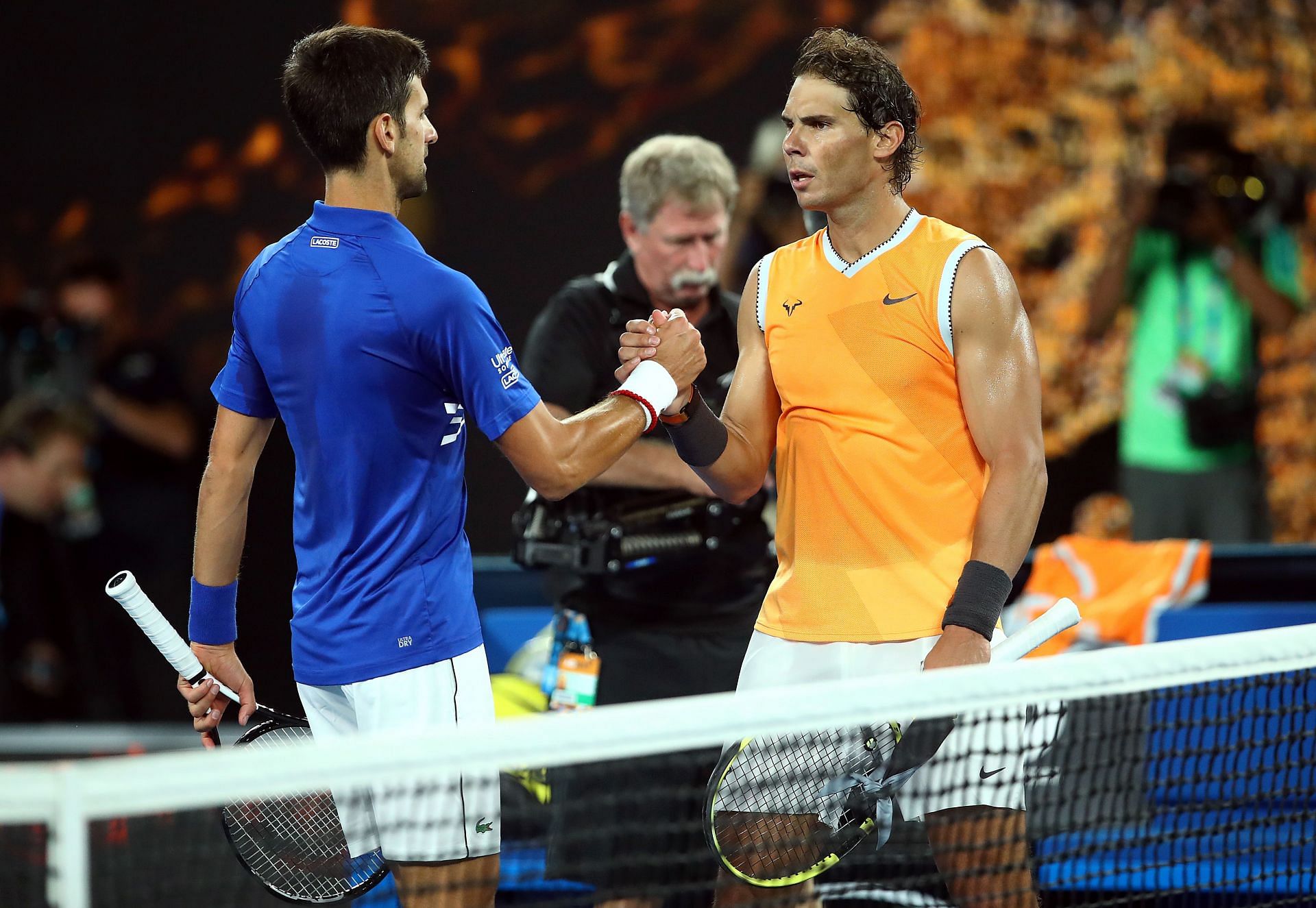 Novak Djokovic (L) and Rafael Nadal shake hands after the 2019 Australian Open final