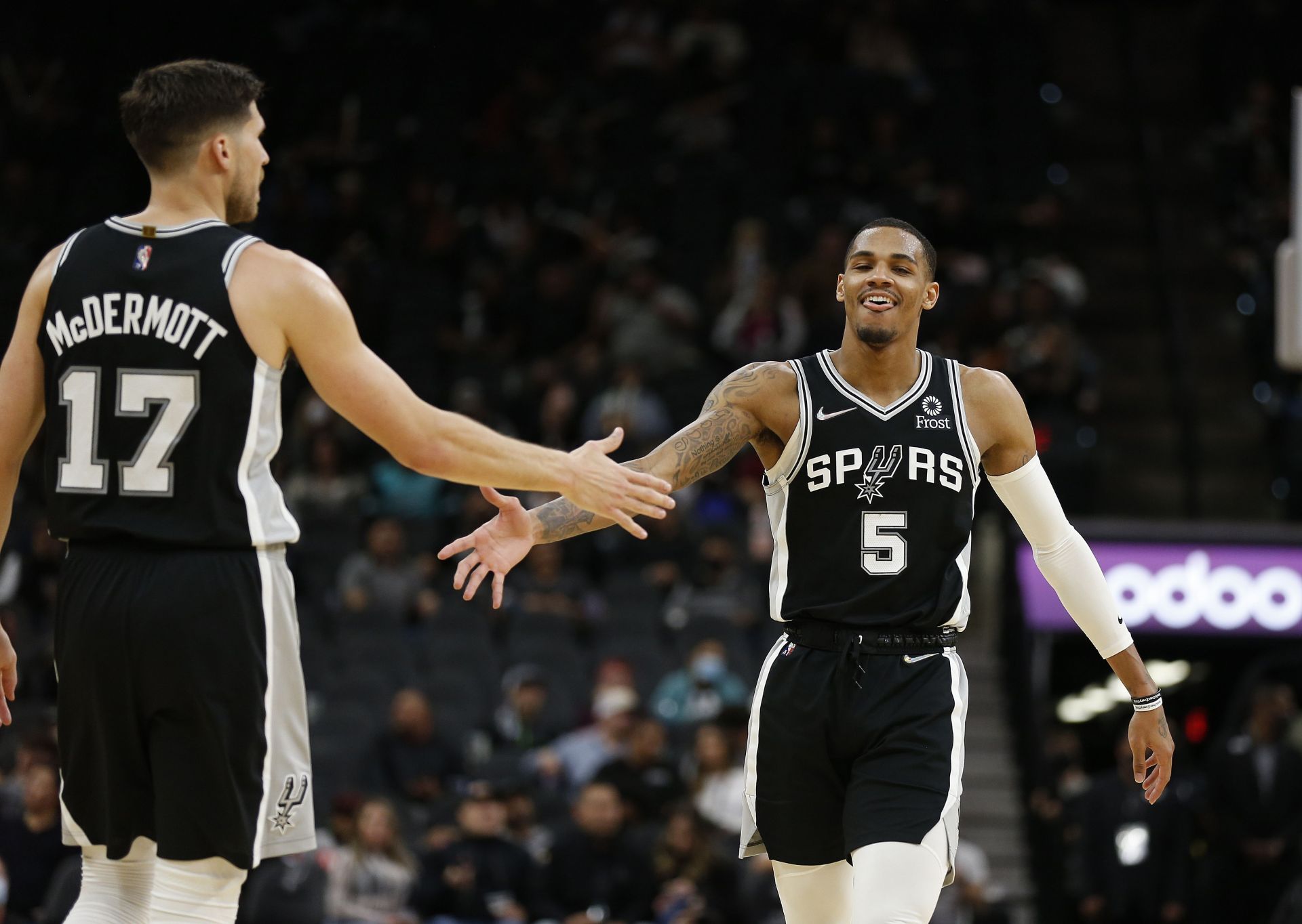 Dejounte Murray of the San Antonio Spurs with Doug McDermott