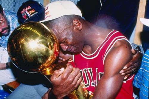 Michael Jordan with the Larry O'Brien NBA championship trophy.