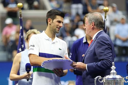 Novak Djokovic poses with the runner-up plate at the 2021 US Open