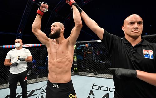 Khamzat Chimaev (center) has his hands raised by the referee following his victory against Rhys McKee on July 26, 2020