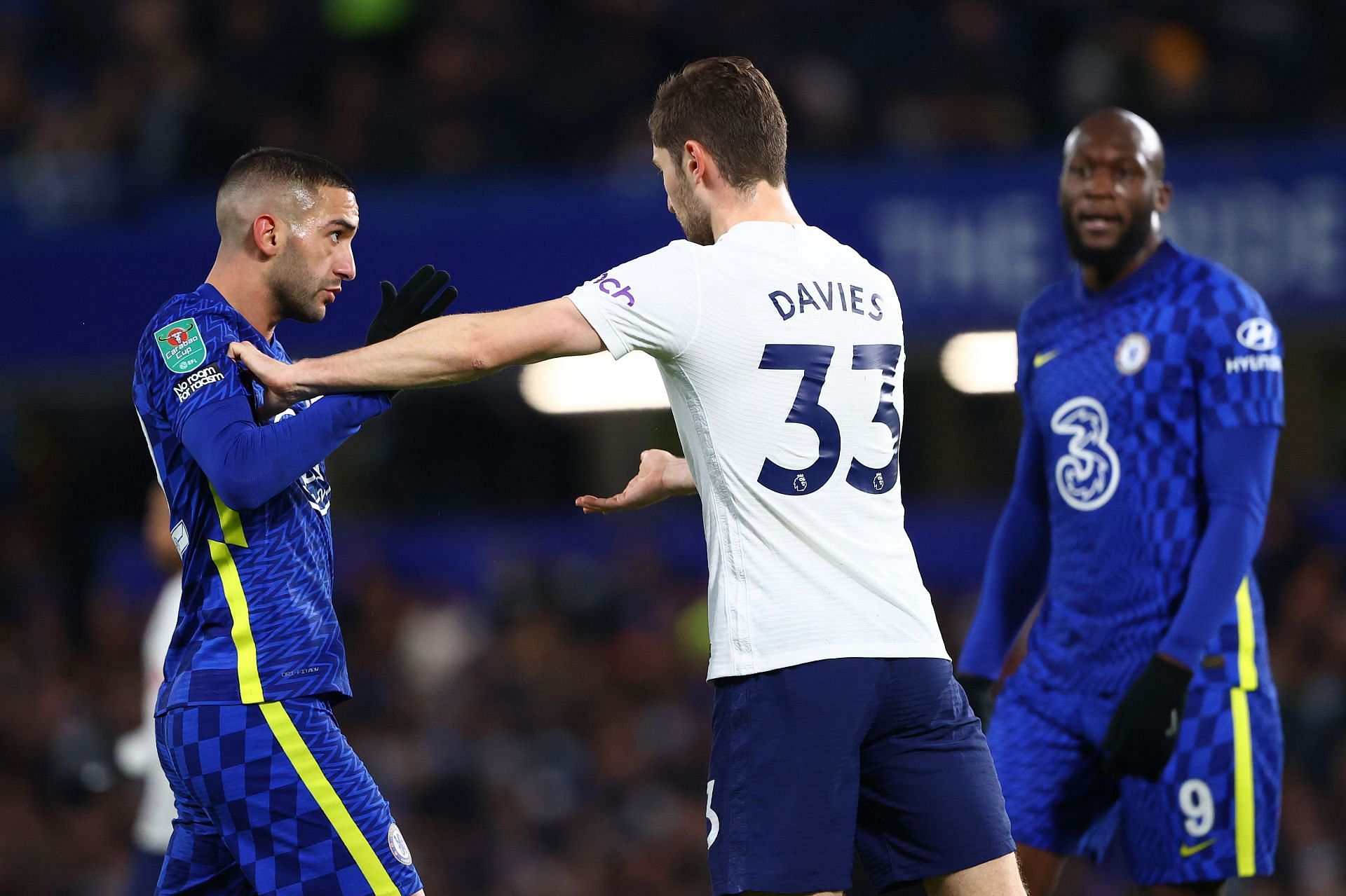 Ben Davies clashes with Hakim Ziyech.