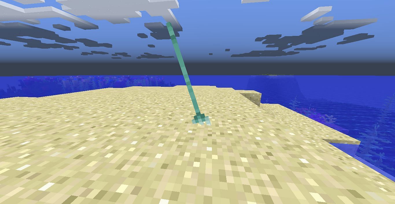 A thrown trident stuck in the ground (Image via Minecraft)