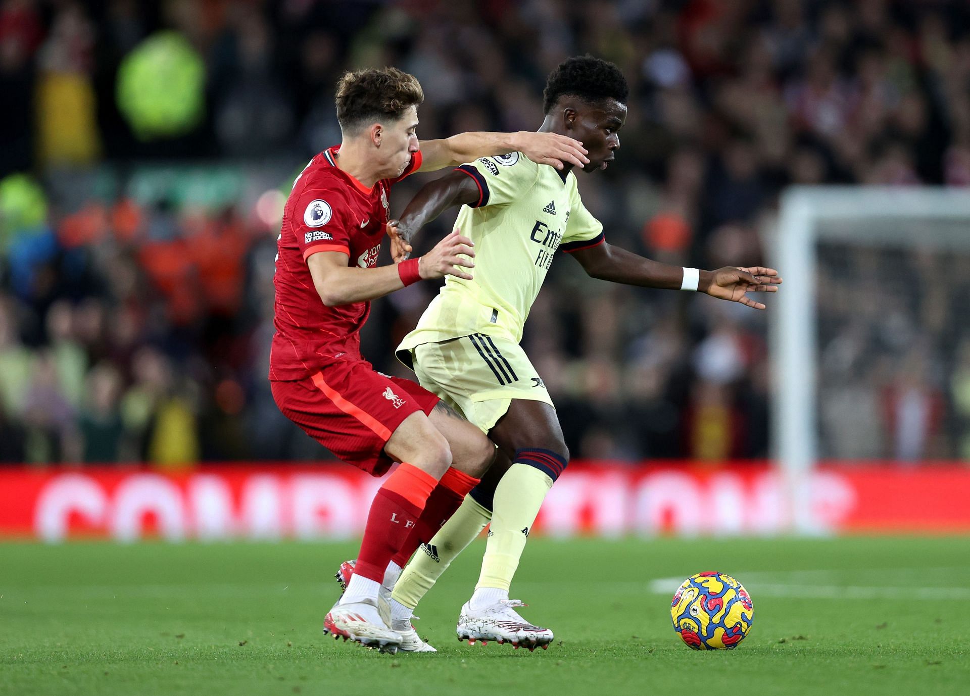 Kostas Tsimikas of Liverpool battles for possession with Bukayo Saka of Arsenal 