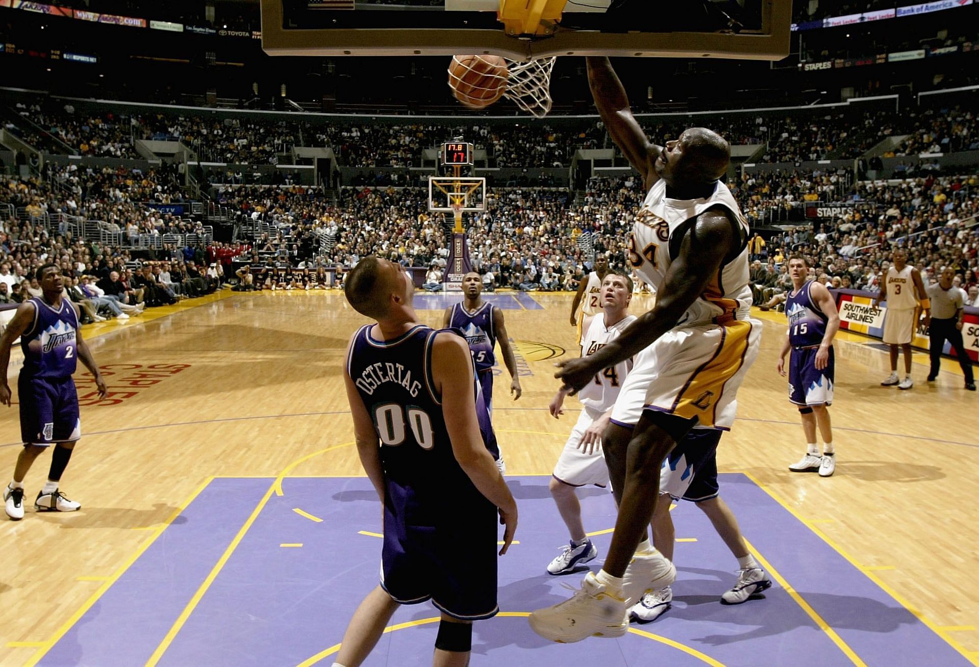 Shaquille O'Neal #32 of the Los Angeles Lakers slams home a basket over Greg Ostertag #00 of the Utah Jazz.