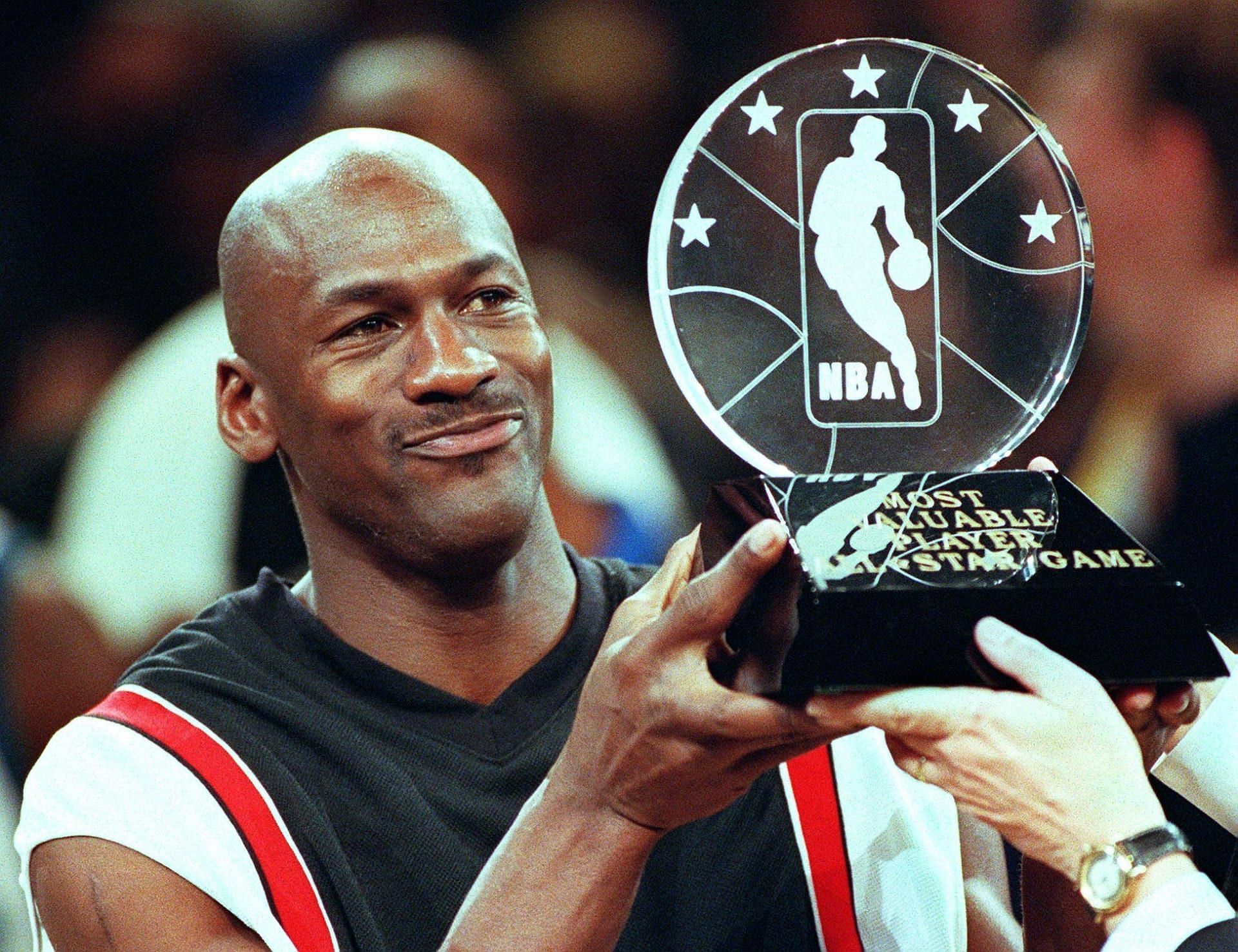 Michael Jordan with the 1998 All-Star Game MVP trophy