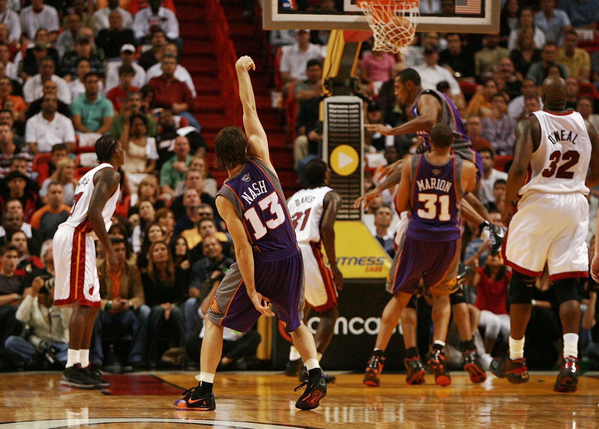 Steve Nash #13 of the Phoenix Suns holds his shooting pose as the ball falls through the net.