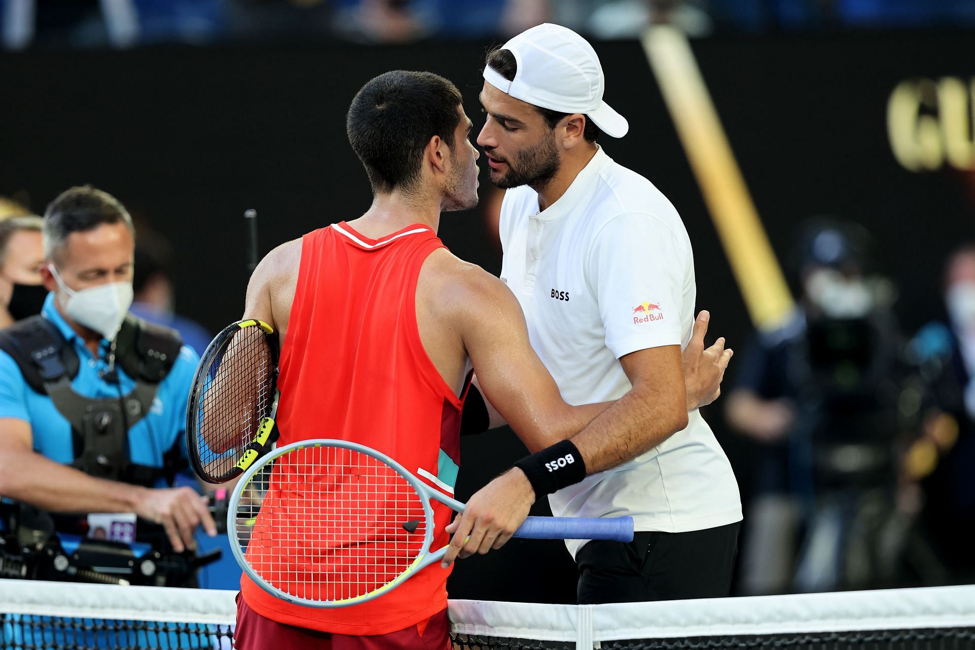 Carlos Alcaraz embraces Matteo Berettini after their marathon five-set match at the 2022 Australian Open