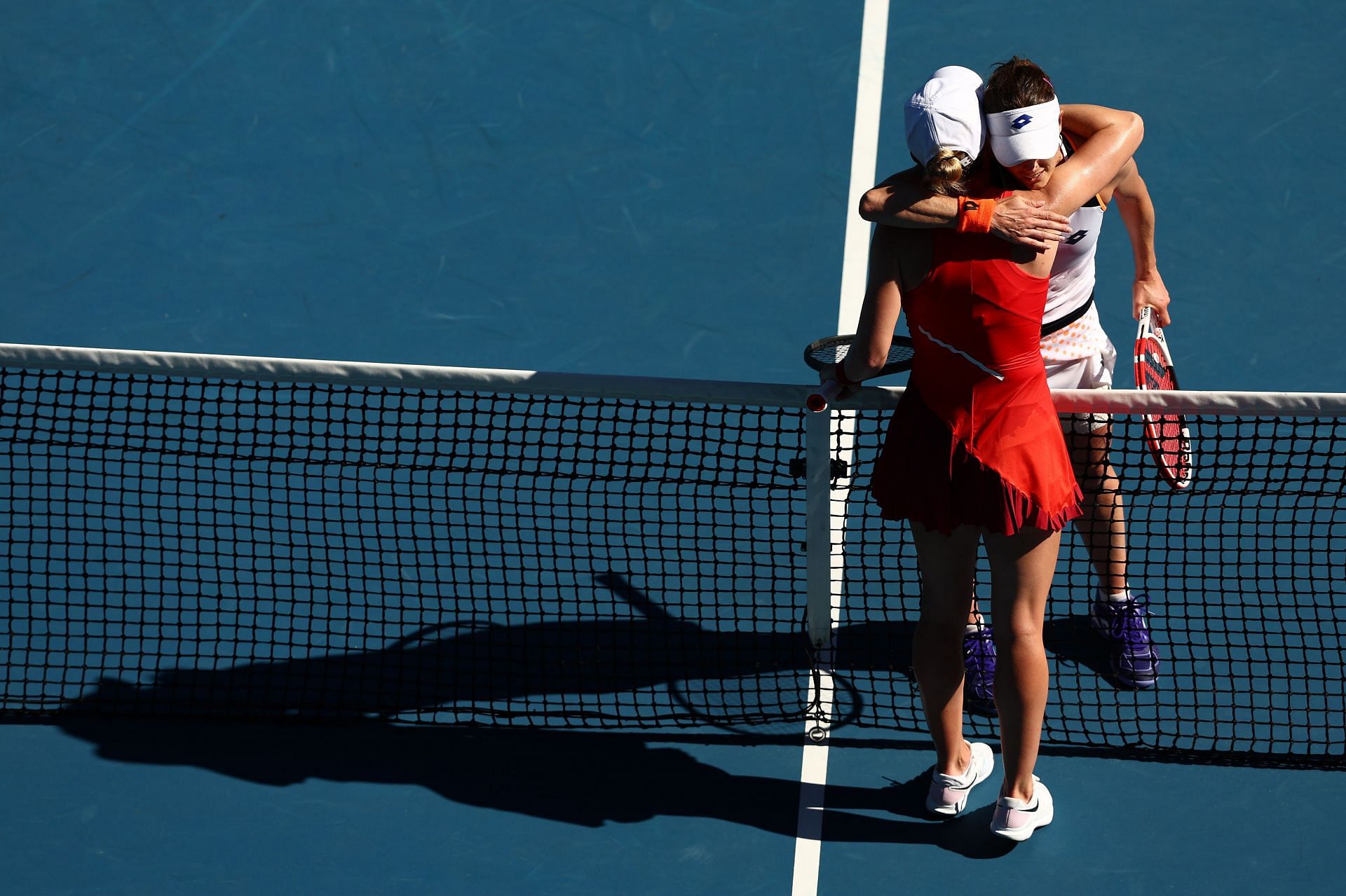 Alize Cornet and Simona Halep embrace after their match