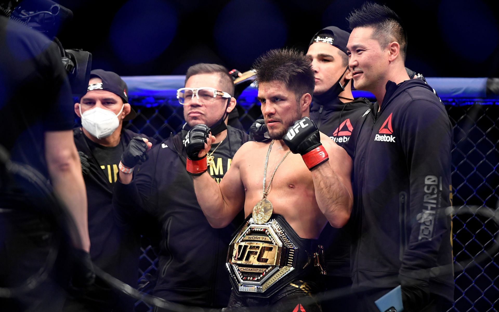 Former two-division UFC champion Henry Cejudo celebrates with his Fight Ready team after a successful title defense