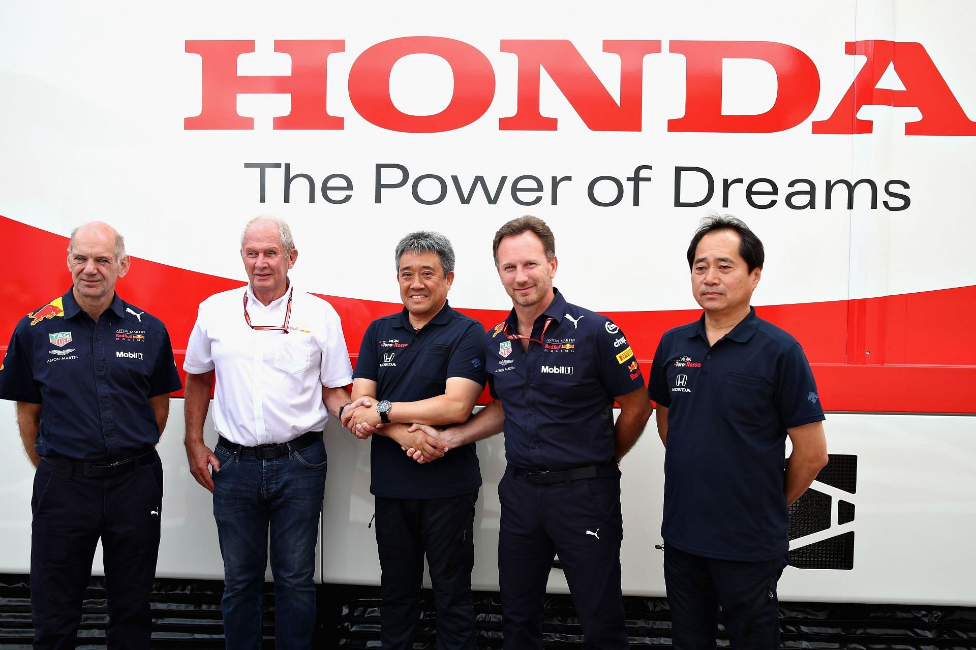 Honda F1 boss Masahi Yamamoto (center) with Red Bull execs Christian Horner (second right), Helmut Marko (second left), and Adrian Newey (extreme left)