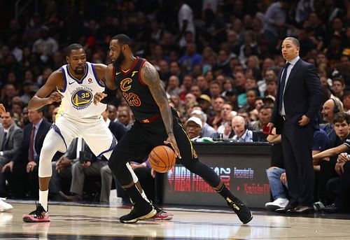 LeBron James (R) handles the ball against Kevin Durant (L).