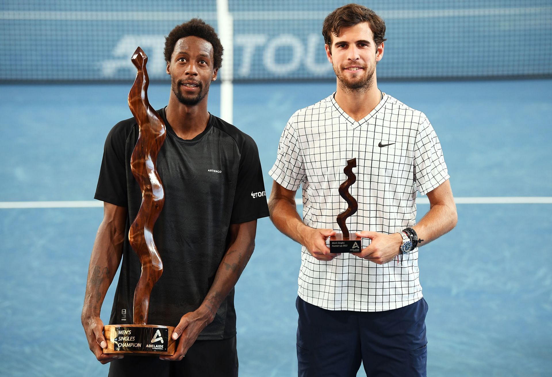 Gael Monfils holds the Mens Singles Champion trophy with runner up Karen Khachanov of Russia at the 2022 Adelaide International at Memorial Drive in Adelaide, Australia.